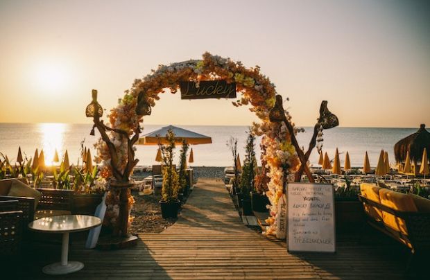 un altar de una boda decorado con flores en una playa de España